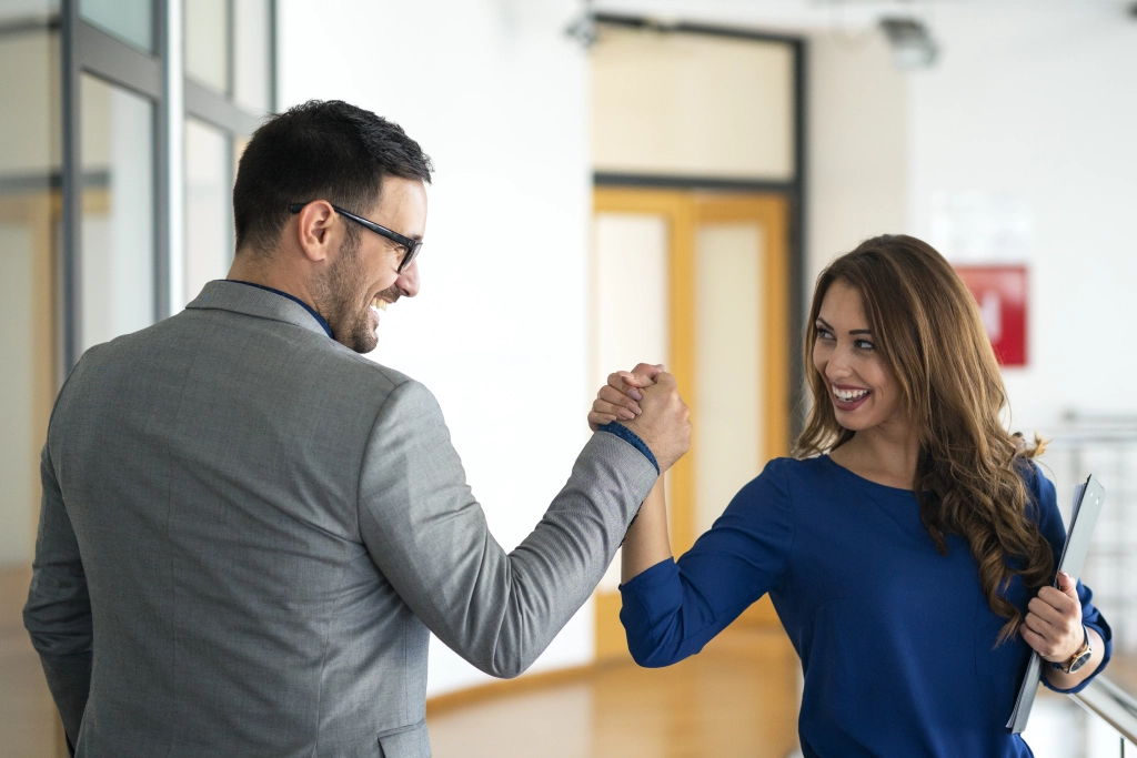 young-successful-business-people-greeting-company-s-office