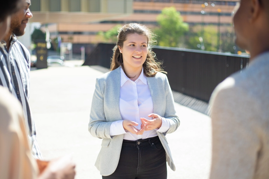 smiling-caucasian-woman-talking-friends-street